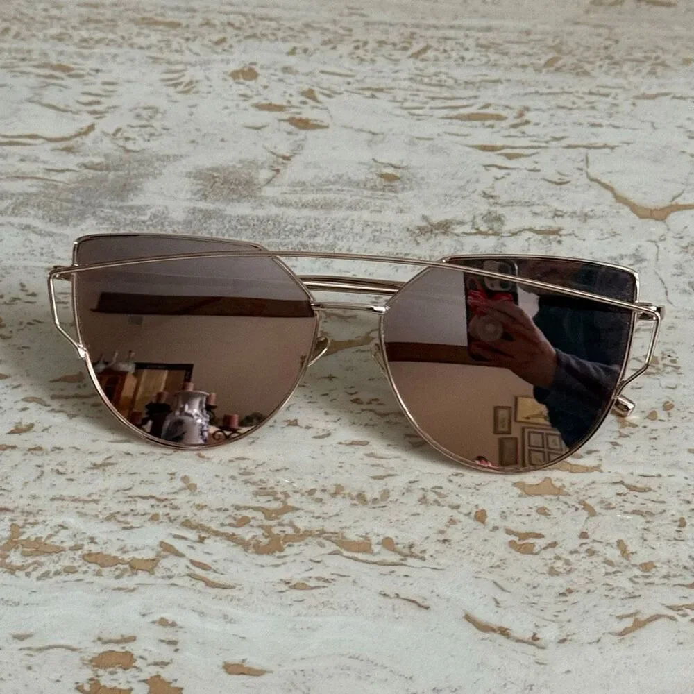 Rose gold wire frame cat eye aviator sunglasses with reflective pink lenses.
